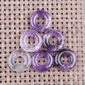 Polished amethyst and clear crystal donut pendants with circular carved patterns - Amethyst