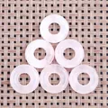 Natural pink quartz donut charms for jewelry making, featuring smooth rose stone texture - Rose Quartz