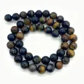Macro view of polished tiger eye stone beads in blue and gold with cat eye effect - Small Style / Blue-Yellow