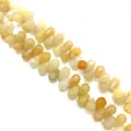 Macro detail of faceted yellow gemstone teardrop beads for DIY jewelry making - 6x9mm / Topaz
