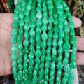 Polished green teardrop natural stone beads for DIY jewelry making held in hand - Green Jade