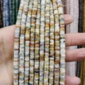 Hand holding multiple strands of natural stone rondelle beads in various organic colors - Small Round Plate Style / Earth Tone Texture (No.9)