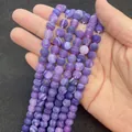Polished round purple weathered agate beads with distinctive dragon vein textures - Purple