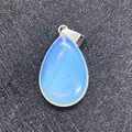 Waterdrop-shaped opalite stone pendant with silver metal clasp on black background - Opal
