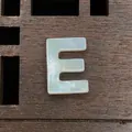 Natural white shell letter E bead with iridescent luster for DIY jewelry making - Letter E