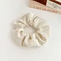 Elegant off-white scrunchie with rhinestones on textured fabric for ponytails - Off White