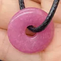 Vibrant rose pink chalcedony donut pendant necklace with black braided cord on hand - Pink Chalcedony (No.8)