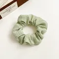 Chic light green textured fabric scrunchie with soft pleats and elegant French style - Green