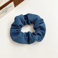 Navy blue pleated fabric scrunchie for ponytails shown on a minimal beige background - Dark Blue