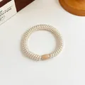 Braided beige high-elasticity hair tie with a light brown oval bead connector - Beige