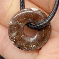 Natural snowflake jasper donut pendant necklace with black woven cord held by hand - Breccia (No.16)