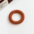 Durable matte caramel brown spiral hair tie in phone cord style for ponytails - Orange