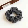 Elegant grey hair scrunchie with black polka dots and soft pleated fabric texture - Grey Polka Dot