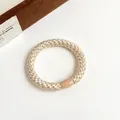Élastique à cheveux tissé doré champagne avec perle ovale pour queue de cheval chic - Poche zippée