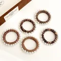 Five-pack leopard and zebra print hair scrunchies with elegant white pearl trimmings - Multicolor