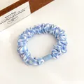 Blue and white checkered fabric scrunchie with a decorative light blue bead detail - Blue
