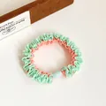 Two-tone mint green and peach pink ruffled scrunchie with a blue bead accessory - Green