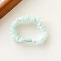 Mint green pearlescent scrunchie with silk luster and matte cylindrical buckle detail - Green