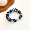 Blue leopard print scrunchie with translucent buckle on neutral textured background - 1# Blue Black Abstract