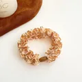 Champagne gold pleated hair scrunchie with a brown decorative oval buckle accessory - Light Coffee
