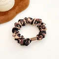 Elastic leopard print scrunchie with silky texture and durable brown plastic clip - Classic Leopard