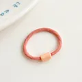 Elastic baby hair tie in light pink color with a smooth cylindrical decorative bead - Dusty Pink