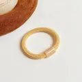 Élastique à cheveux tressé jaune chaud avec perle cylindrique en résine lisse - Jaune Terre