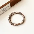 Brown and cream woven high-elastic hair tie with durable brown cylindrical buckle fastener - Brown