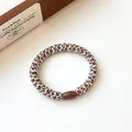 Elastic braided hair tie in coffee tones featuring a metallic fiber weave and brown bead - Gray