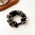 Elastic black fabric hair tie with golden wavy edge trim and black resin bead - Black