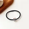 Elastic black hair tie featuring a sparkling iridescent crystal bead for women - Black