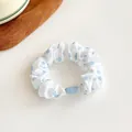 White scrunchie with blue polka dots featuring a minimalist elastic fabric design - Blue