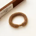 Deep brown plush knit elastic hair scrunchie with a glossy buckle fastener - Turmeric