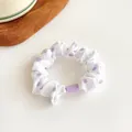 White polka dot hair scrunchie with purple accents and stylish plastic buckle detail - Purple