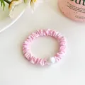 Pink fabric scrunchie with large white pearl accent and elegant pleated design - Pink