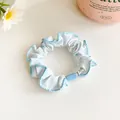 Light blue flower hair scrunchie with bow print and decorative plastic bead detail - Blue