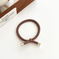 Elastic knotted hair tie in brown finish with golden metal hardware cylinders - Brown