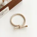 Beige knotted elastic hair tie with textured braid and elegant gold metal end caps - Beige