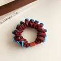 Polka dot hair scrunchie in dark red with blue wavy edges and square accent - Brick Red