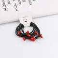 Detail of four elastic hair ties with red beads on a clean white accessory card - Cherry Red Beads Style / Red