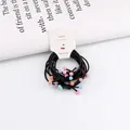 Detail of black elastic hair bands with matte colorful beads on white card packaging - Cherry Multicolor Beads Style / Colorful