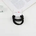 Pack of black high-elastic hair ties set on white aesthetic lifestyle background - Black