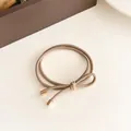 Durable milk coffee bow hair tie with high elastic double strands and gold tips - Khaki