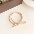 Elastic beige bow hair tie with gold metal tips for durable ponytail styling - Beige