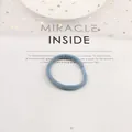 Macro shot of light blue plush scrunchie with elastic hair tie on a decorative background - Blue