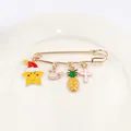 Detailed close-up of a golden safety pin brooch featuring colorful enamel cartoon charms - Star Whale And Pineapple Style (4号款式)