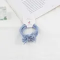 Morandi light blue braided hair tie with tassel knot on a white display card - Blue