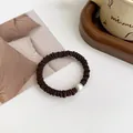 Elastic deep brown scrunchie with white pearl detail on minimalist white background - Dark Coffee