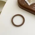 Dunkelbraunes Spiral-Haargummi mit hochelastischem, glänzendem Finish - Dunkelbraun