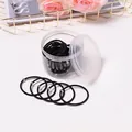 Lot d'élastiques noirs avec perles dorées dans un flacon cylindrique transparent - Perle / Noir